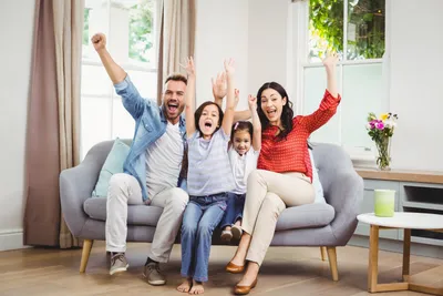 cheering family on a sofa