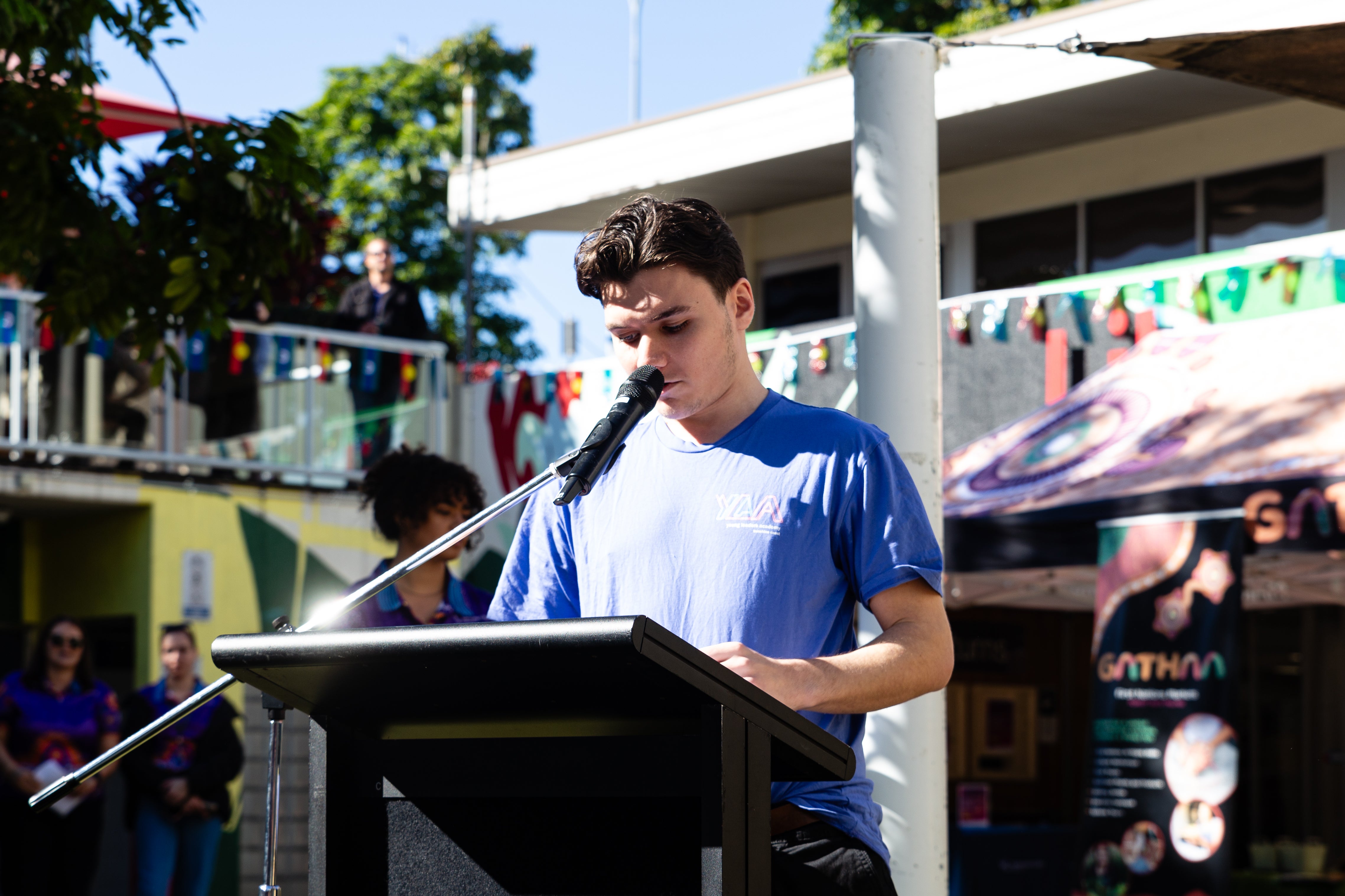 Youth speaking addressing the crowd. 