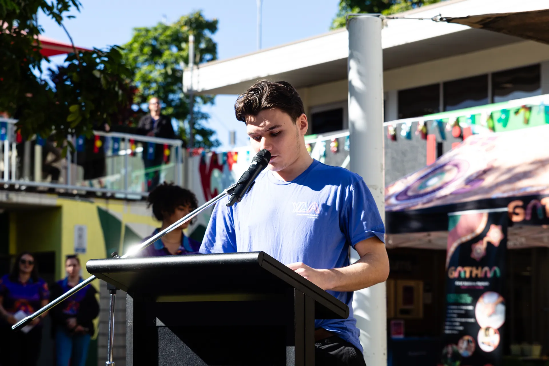 Youth speaking addressing the crowd.