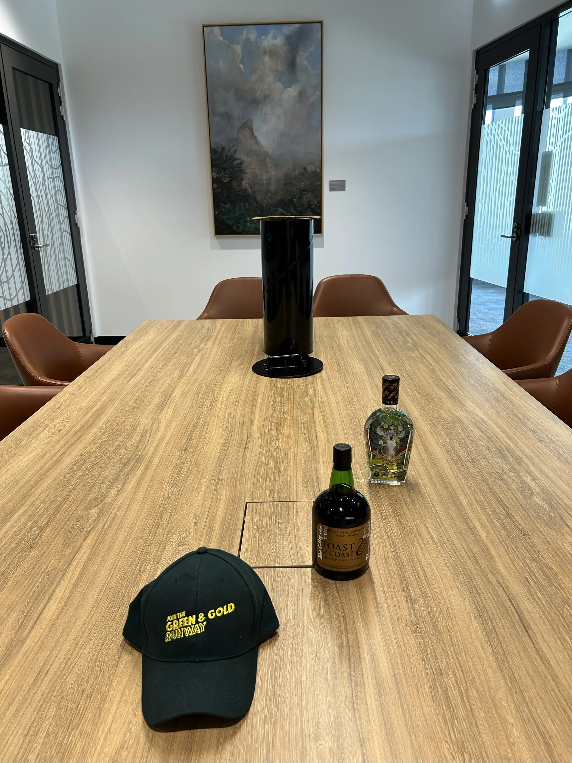 Timecapsule in background, a bottle of Tyrell’s Toast to the Coast 2000 Fine Old Tawny Port, Beachtree Gin and Green and Gold Runway cap.