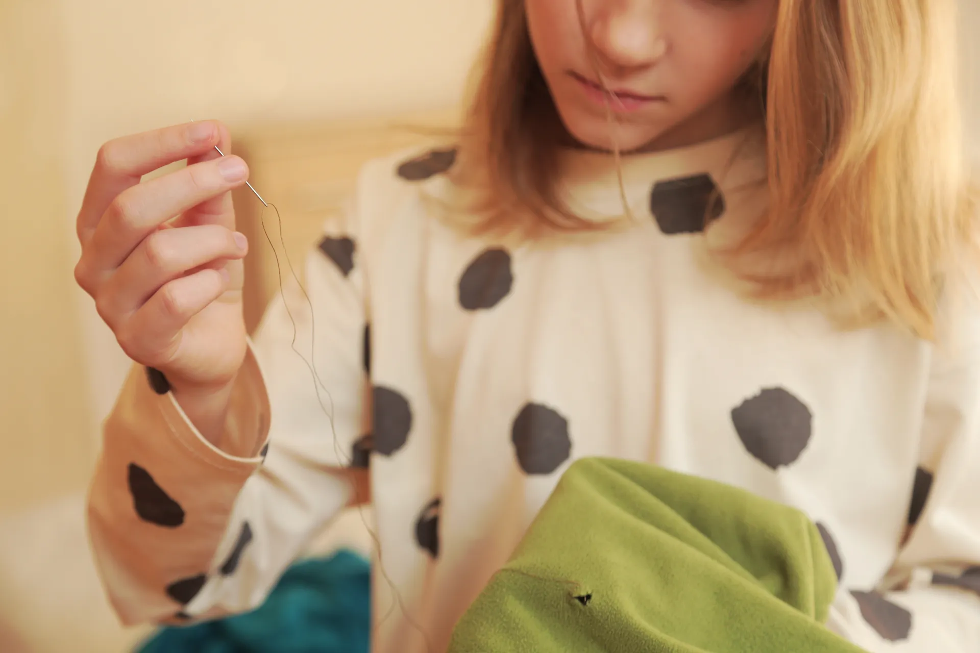 lady mending a hole in a garment