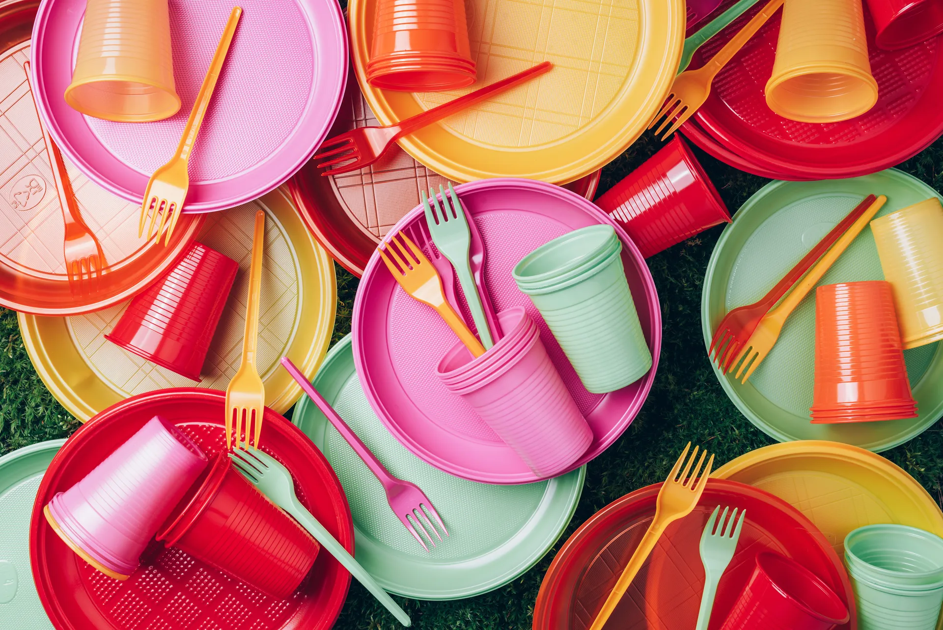 A selection of coloured plastic cutlery and plates