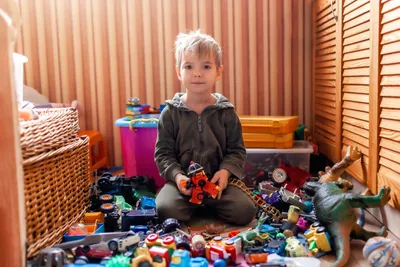 boy in a room full of toys