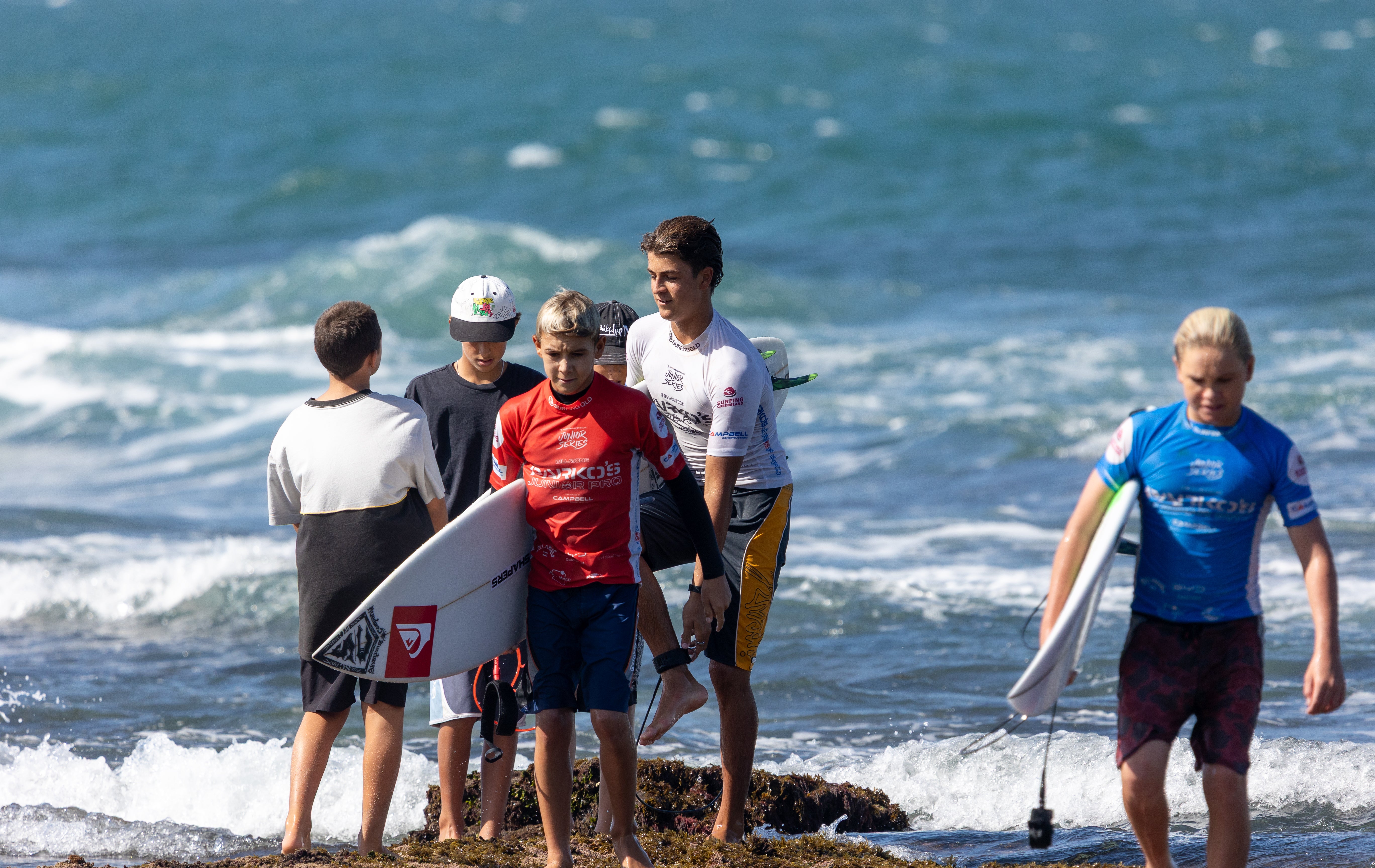 A group of children coming in from the surf