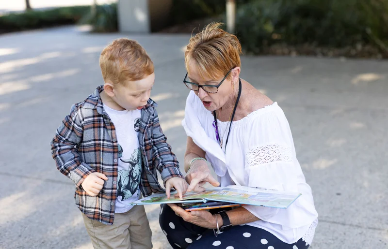 Adult and child reading a book