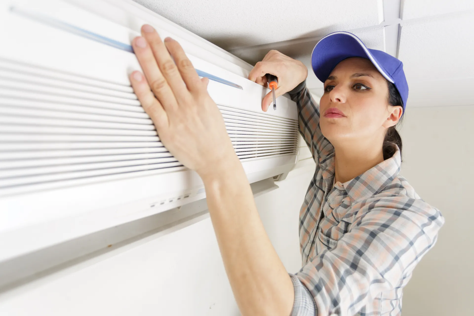 lady removing the air con cover