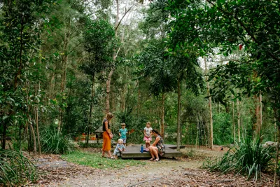 Two women and three young children together at the Maroochy Regional Bushland Botanic Gardens.