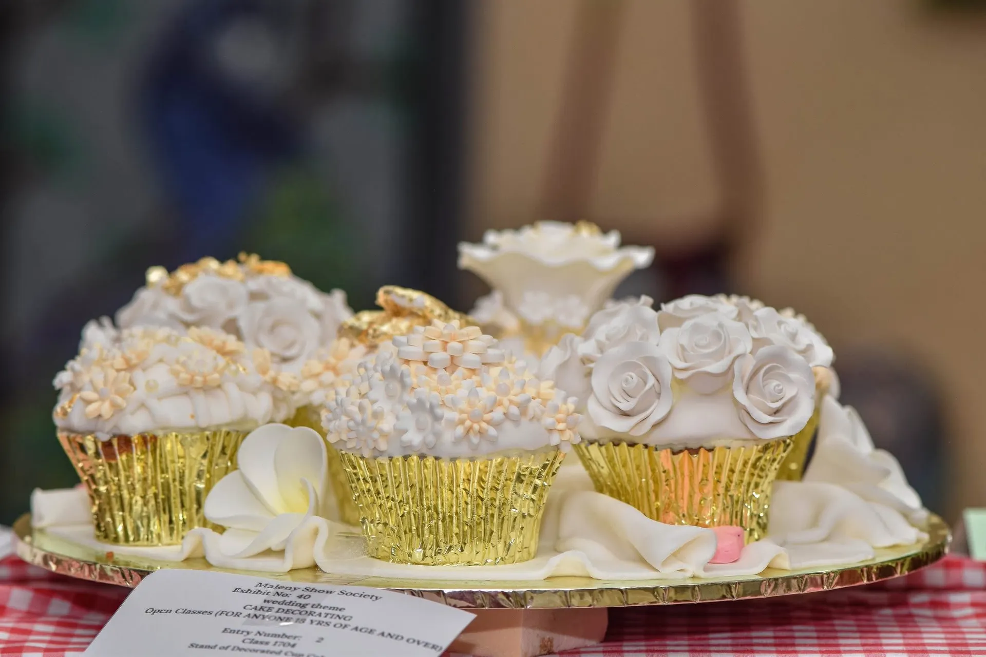 Beautifully decorated cupcakes in gold foil cup cake patties.