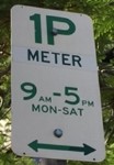 Timed parking sign with times, days and arrow pointing right and left.
