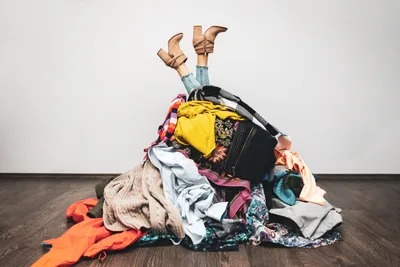 ladies legs and boots sticking out of a pile of clothing