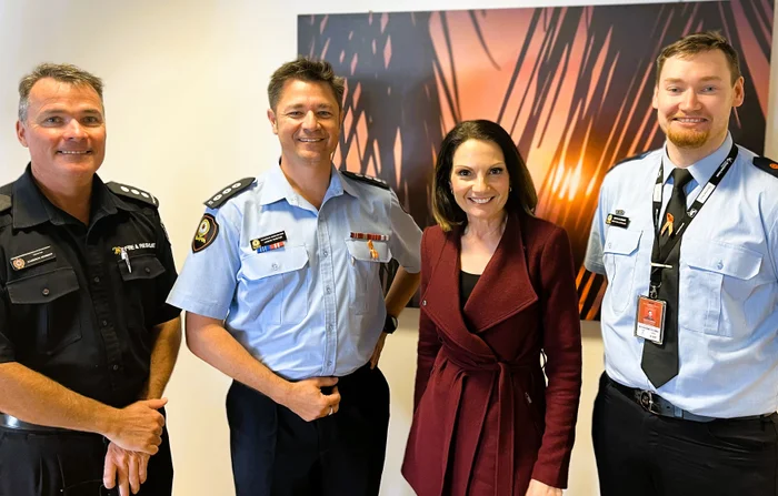 Local Disaster Management Group Chair, Mayor Rosanna Natoli with three men in uniform who are first responders with the Sunshine Coast Local Disaster Management Group.