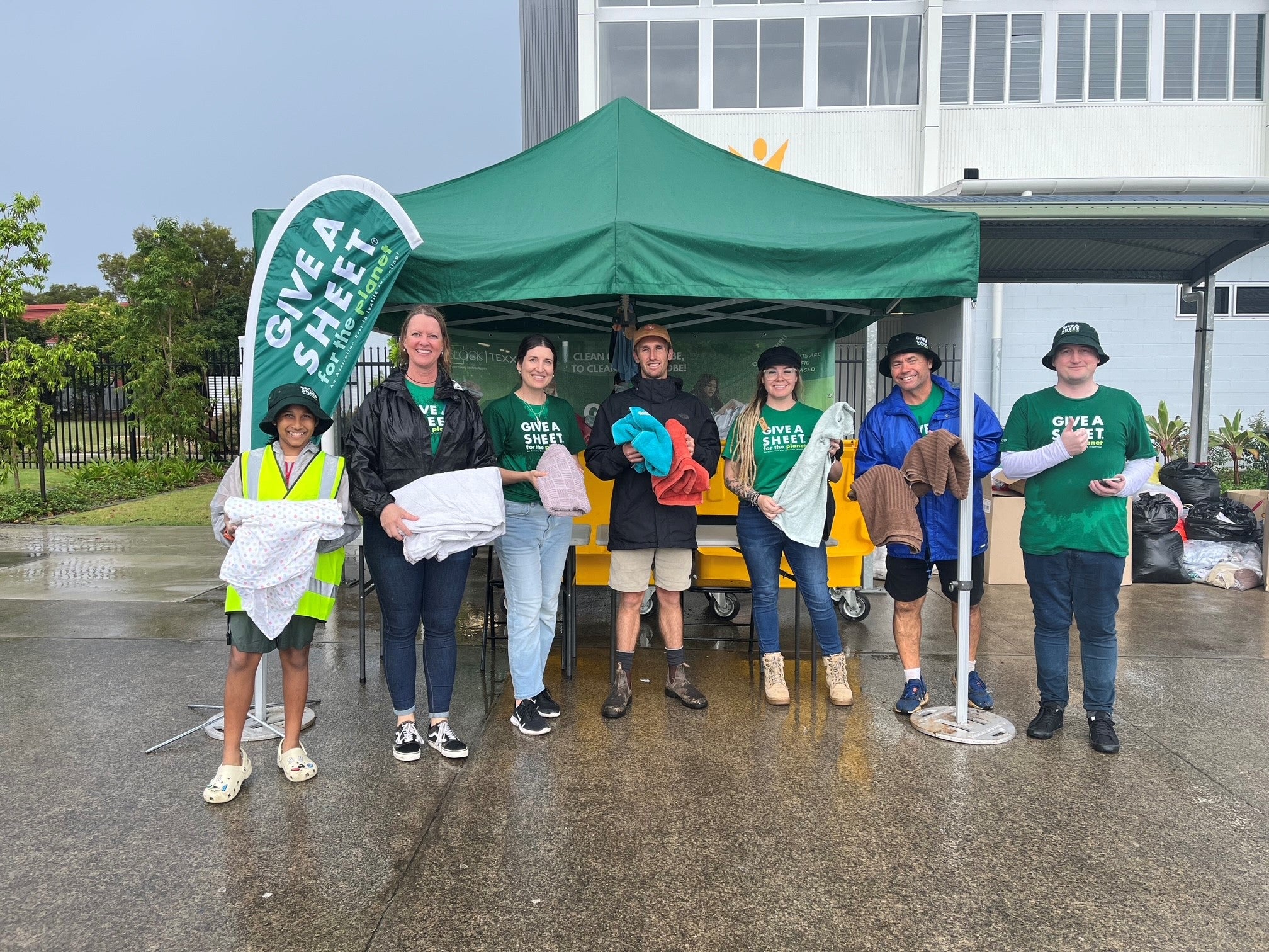 Volunteers holding donations at the 2024 Give a Sheet event