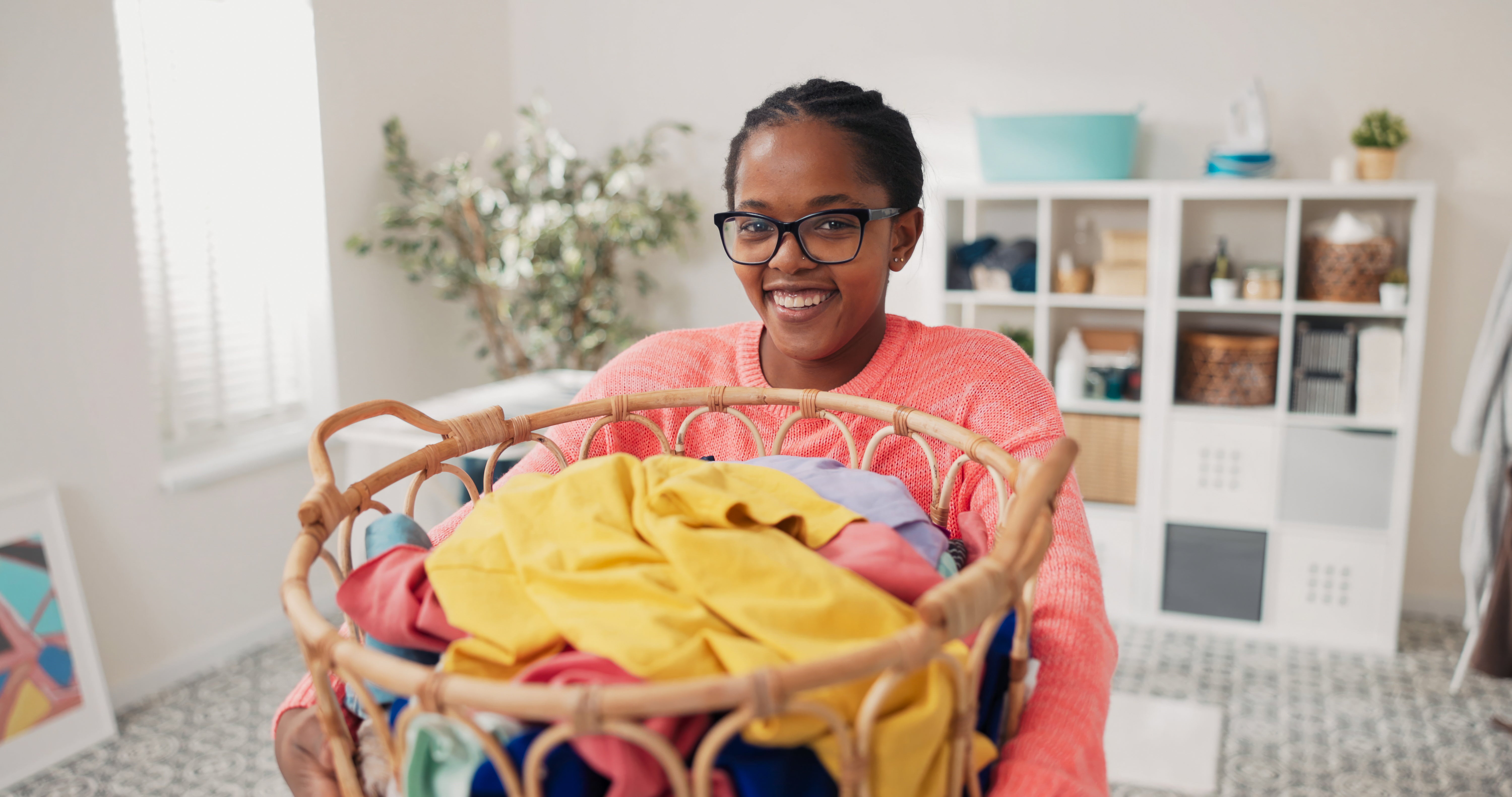 lady holding a wash basket full of sheets