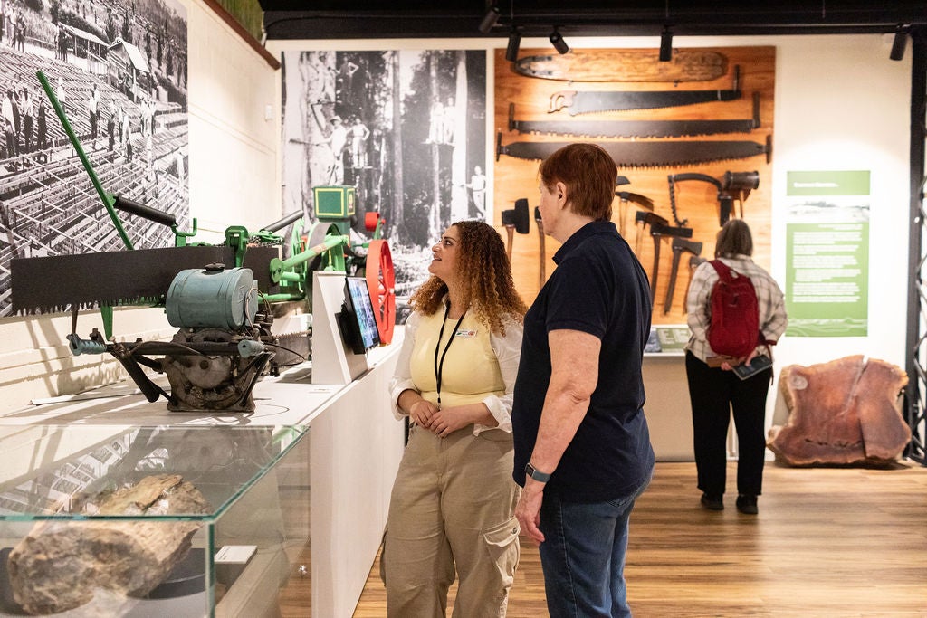 guide and visitor enjoying the Scott Sisters exhibition