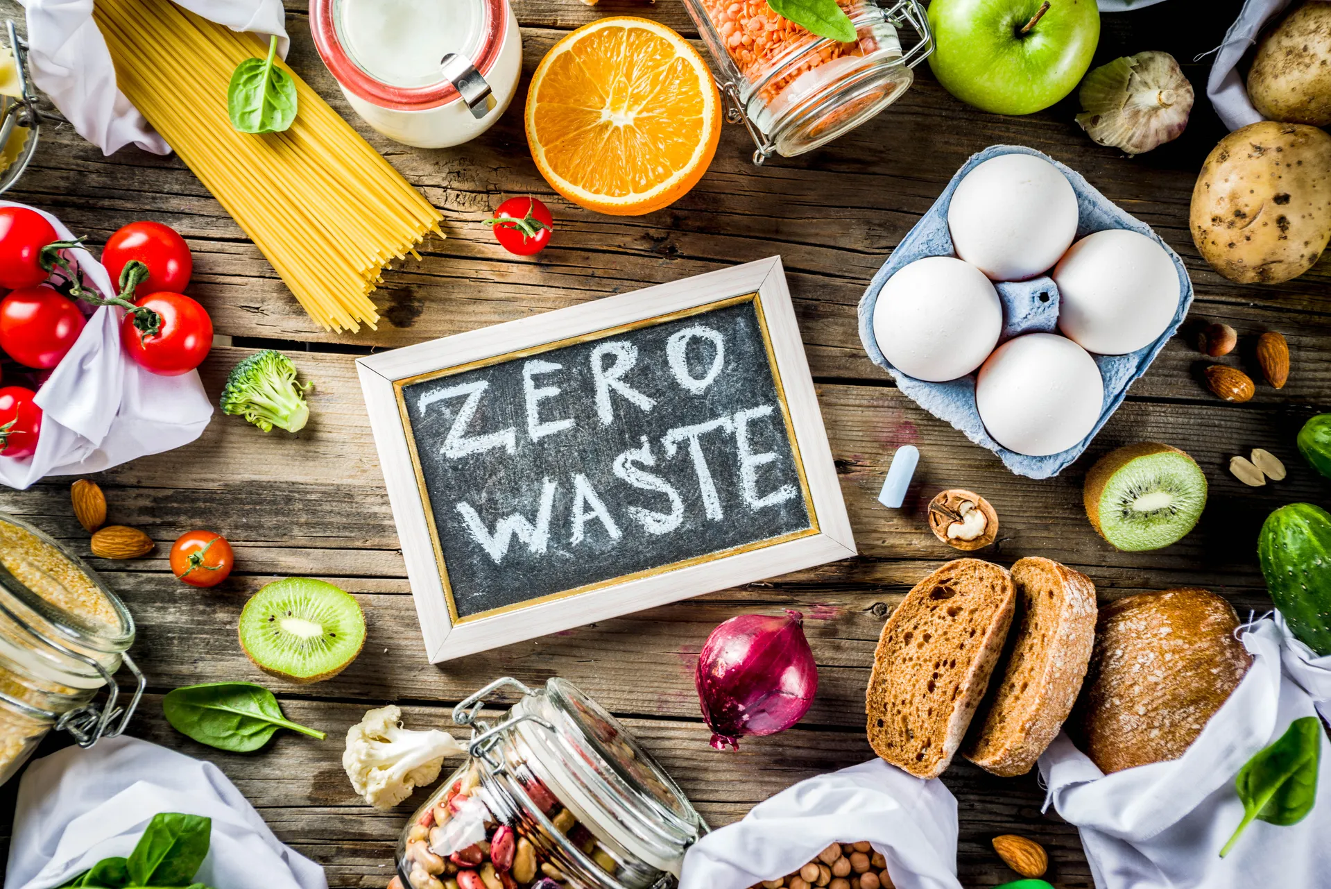 food on a table with a zero waste chalkboard sign in the middle