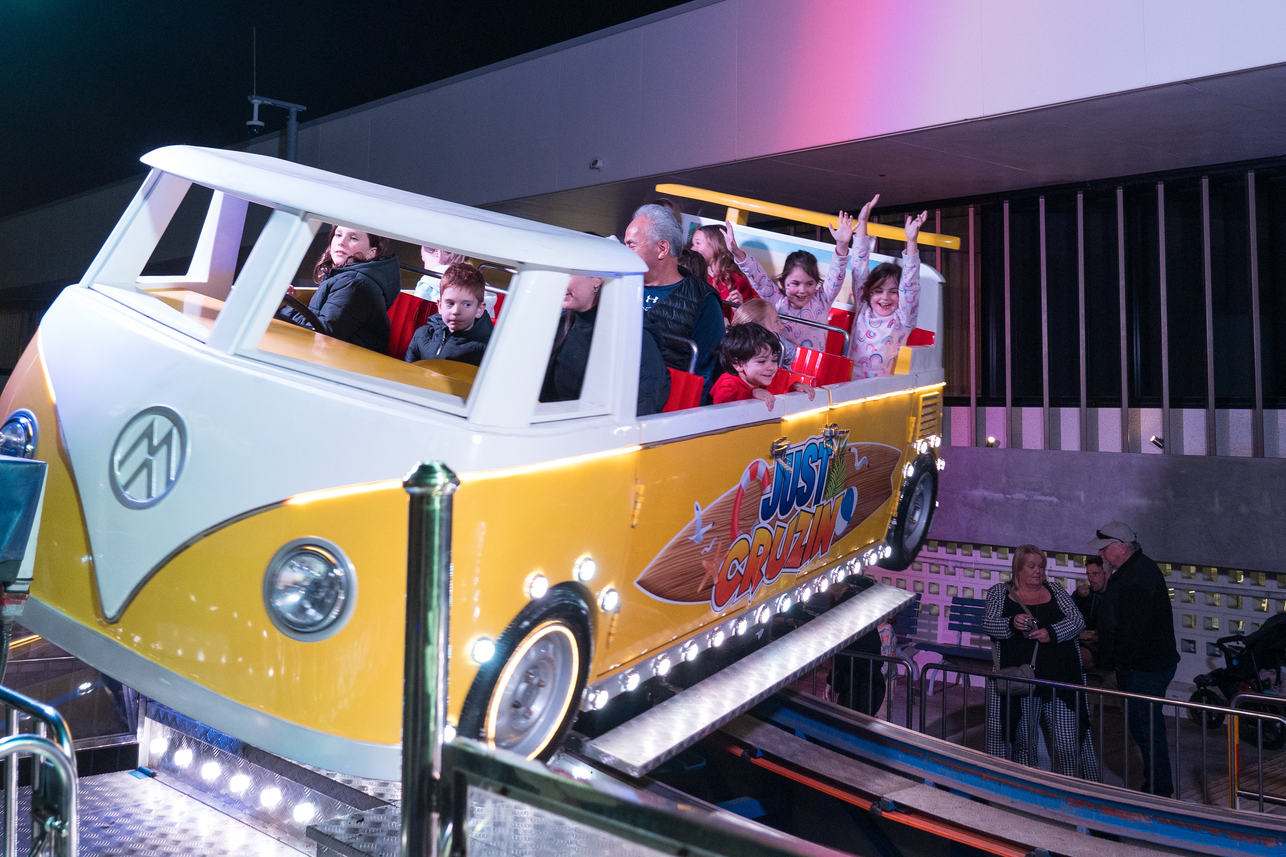 A Combi van as a ride, with kids in the back seats throwing their arms up