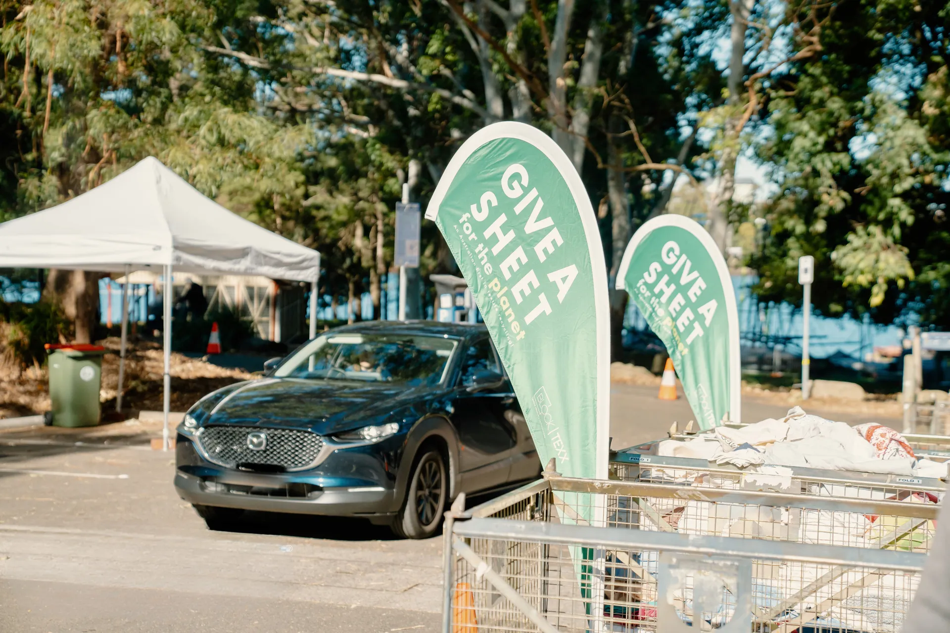 Car driving through Give a Sheet event space