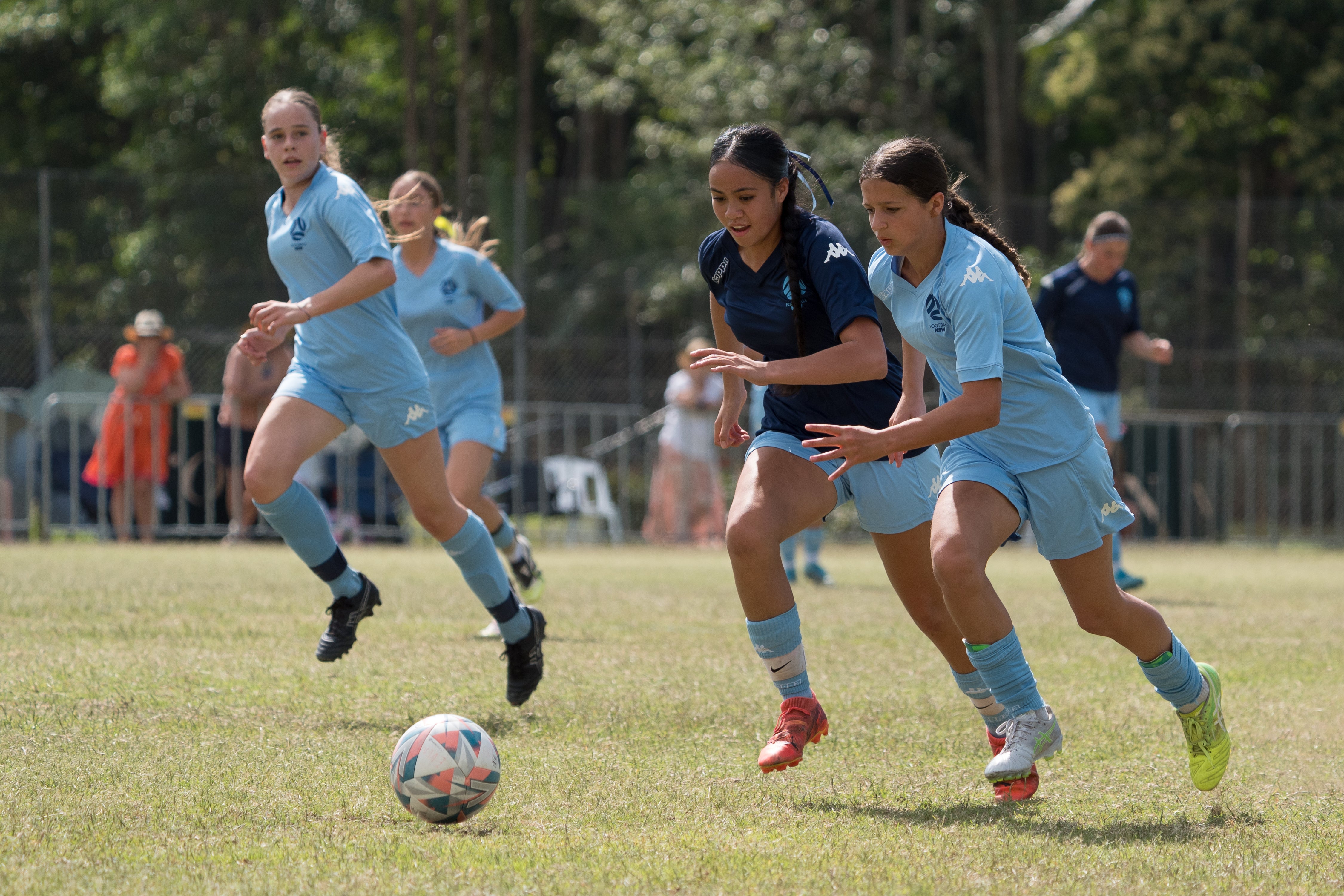 Young women playing football (soccer).