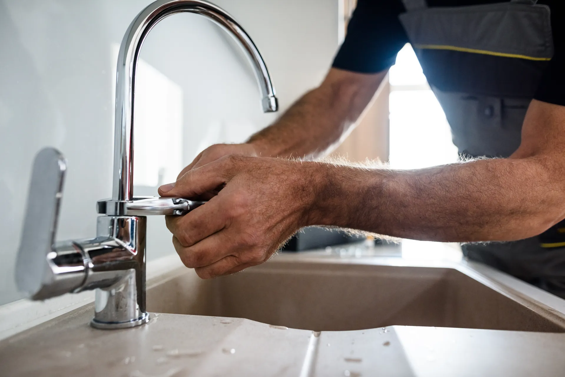 man fixing a tap