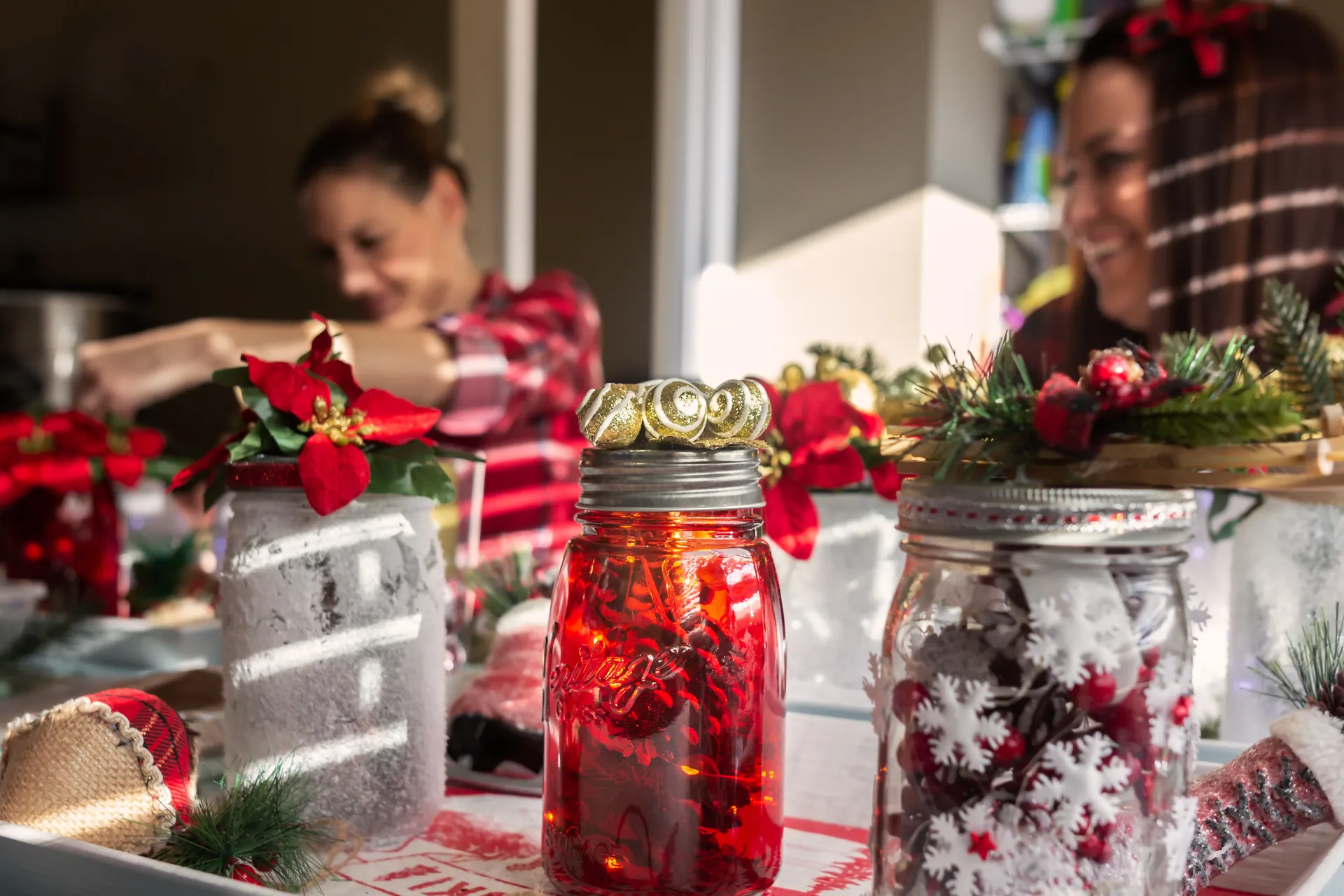Mother and daughter making gifts in glass jars