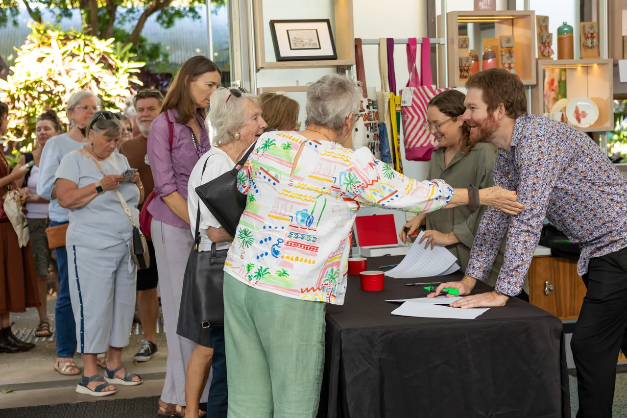 Crowds of people waiting to enter the gallery at the Wildflowering by Design exhibition launch