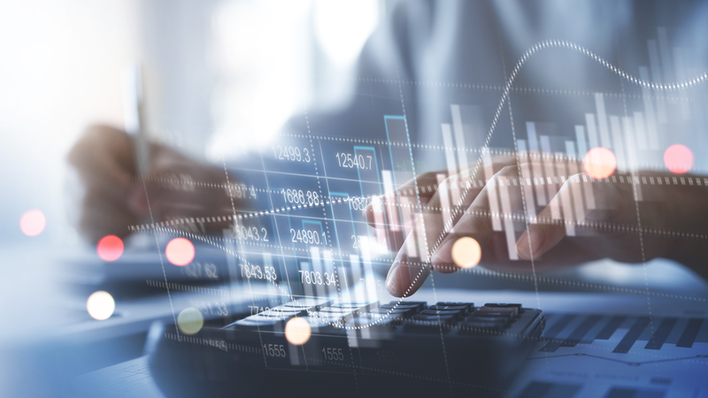 Stock image of financial graphs and typing on a key board.