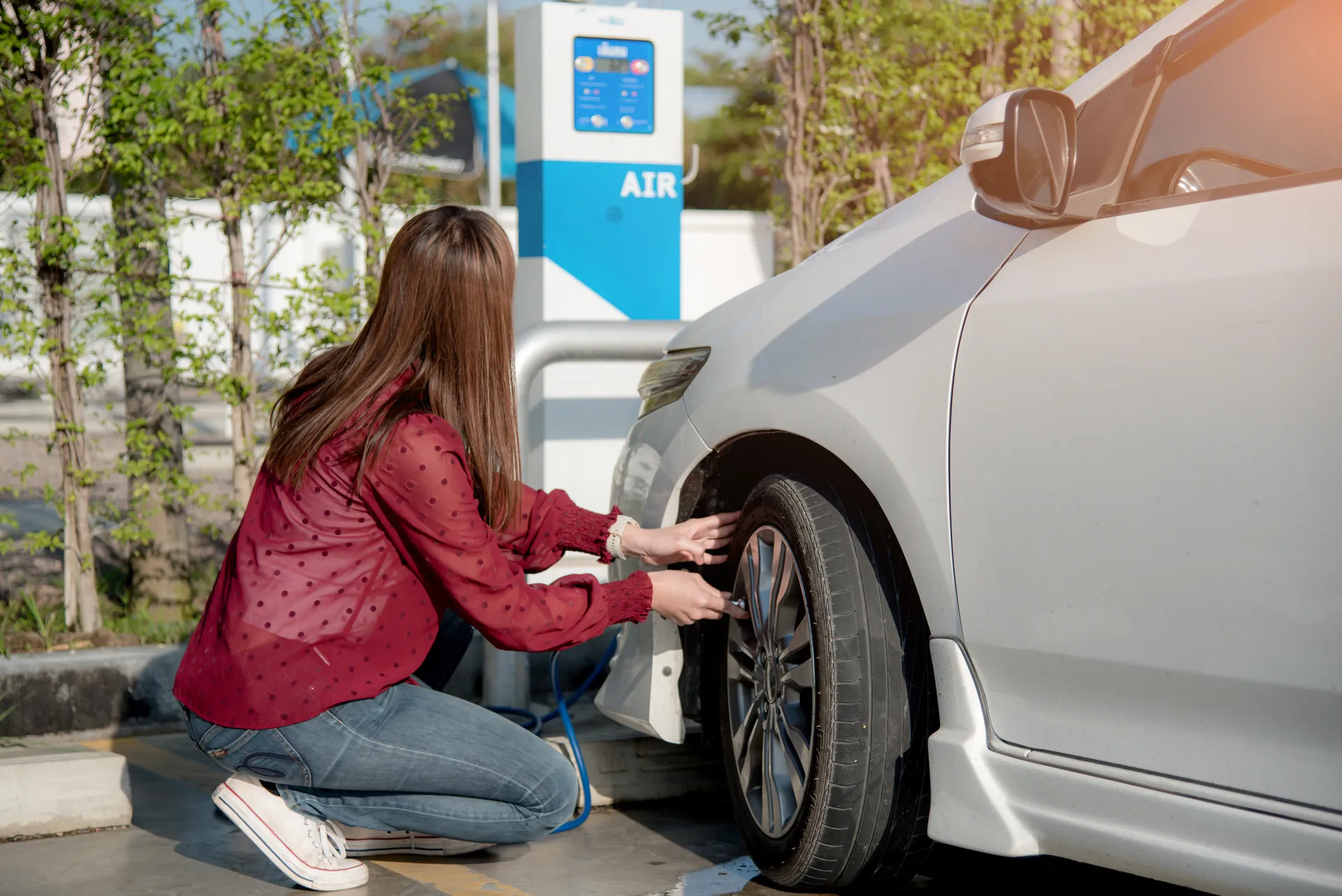 Lady checking tyre pressure