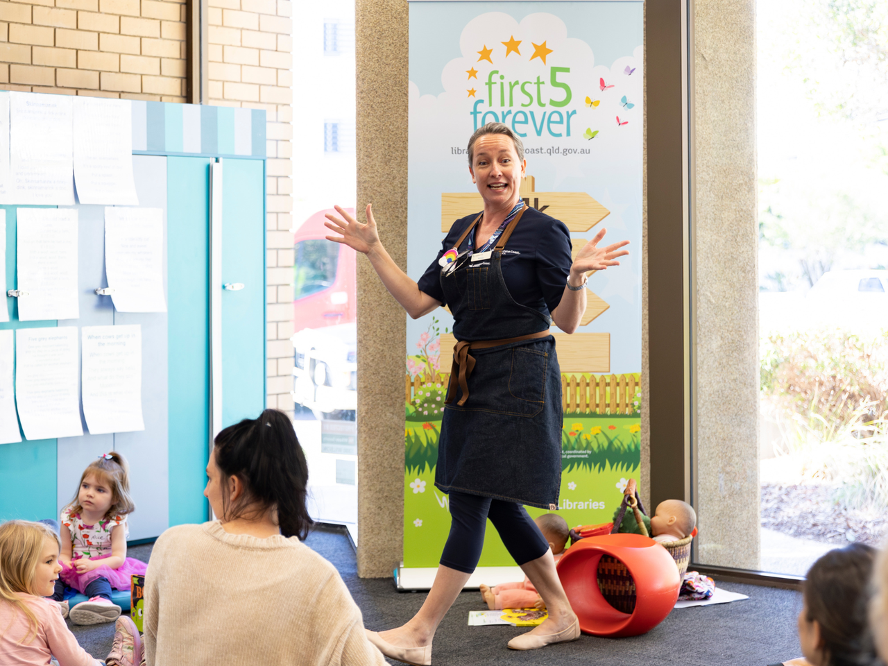 Sunshine Coast Libraries staff speaking to a group of families and children.