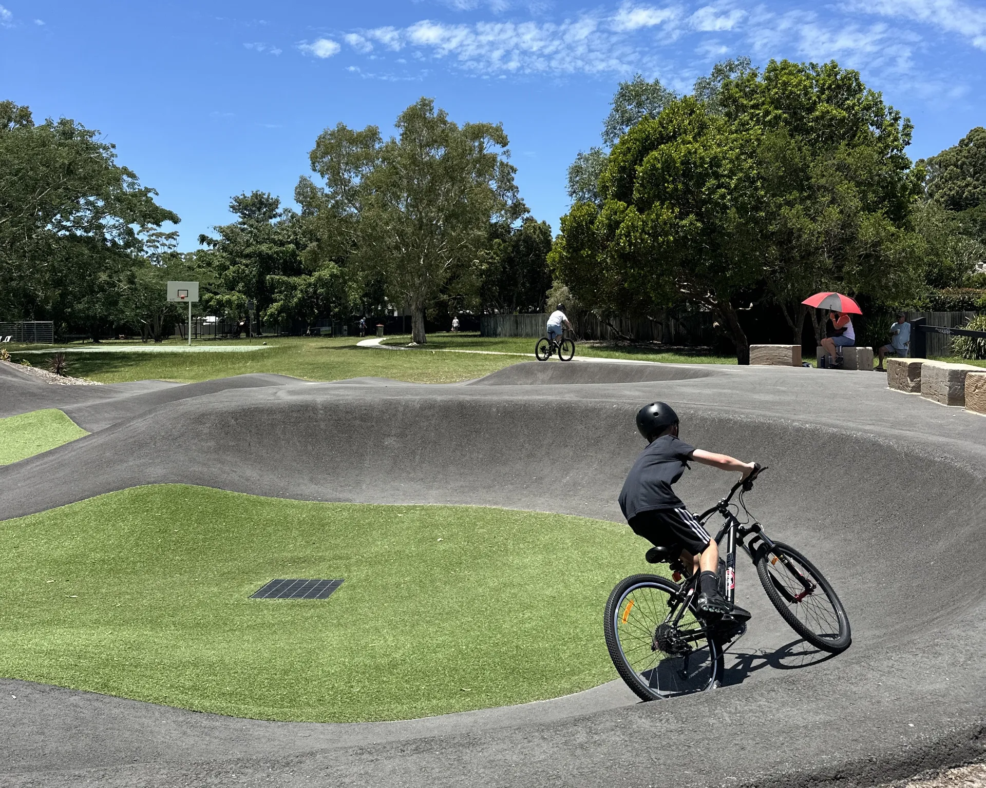 Two boys on mountain bikes at pump track
