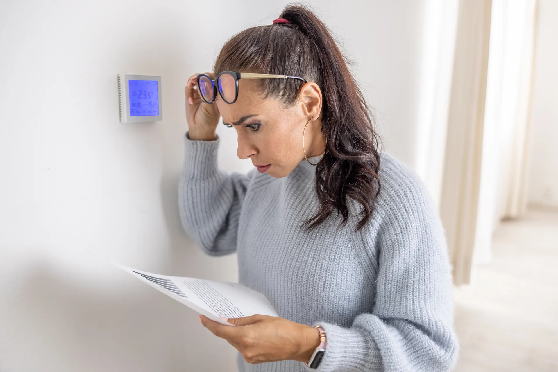 a lady in shock looking at her latest power bill