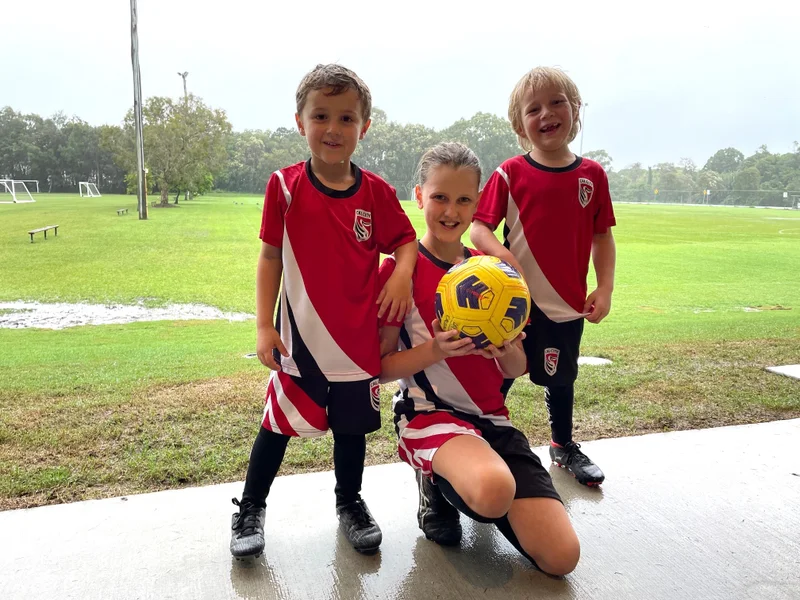 Young Caloundra City Soccer Club players - Hunter, Kayla and fourth generation club player James Ronan