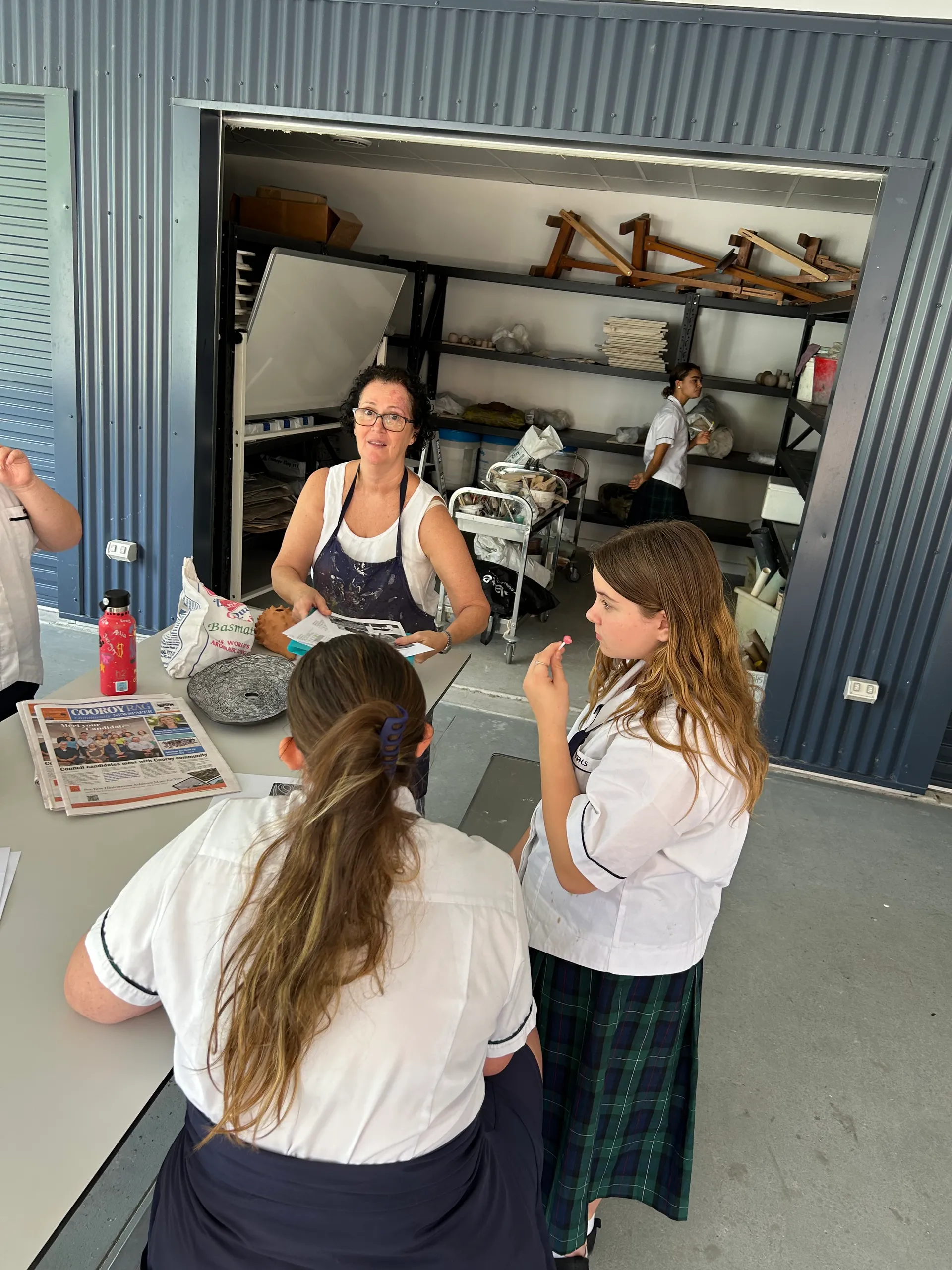 Burnside State High School teacher Ms Mills with students Cytivah and Trinity working on pieces at the pottery studio
