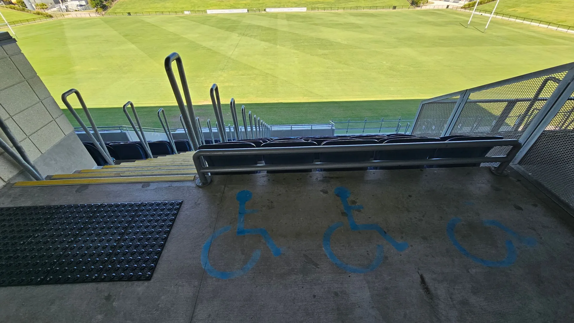Showing wheelchair icons on the concrete floor at Sunshine Coast Stadium to illustrate the seating area for people in wheelchairs