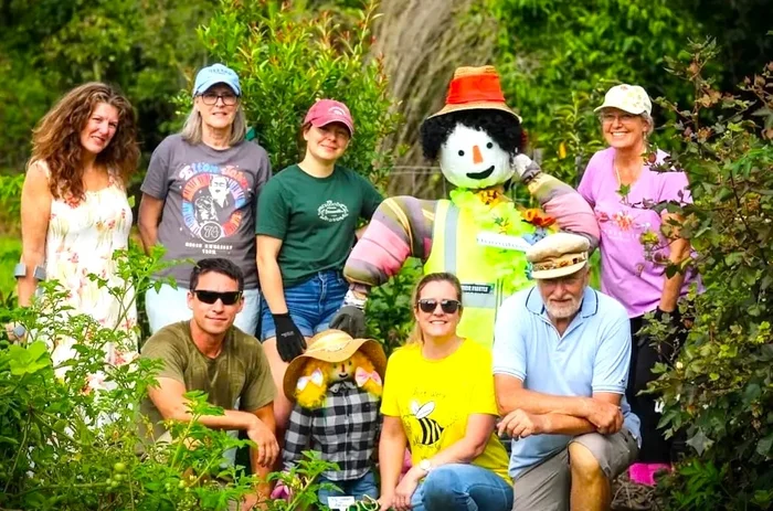 Little Mountain Community Garden group volunteers pose with their scarecrow.