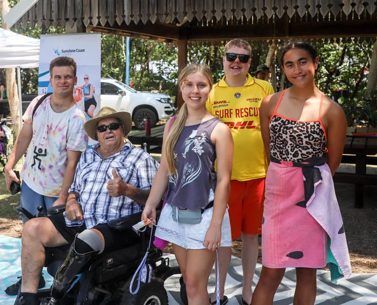 A group of people smiling in the park