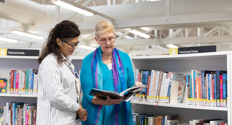 Library volunteer helping a customer