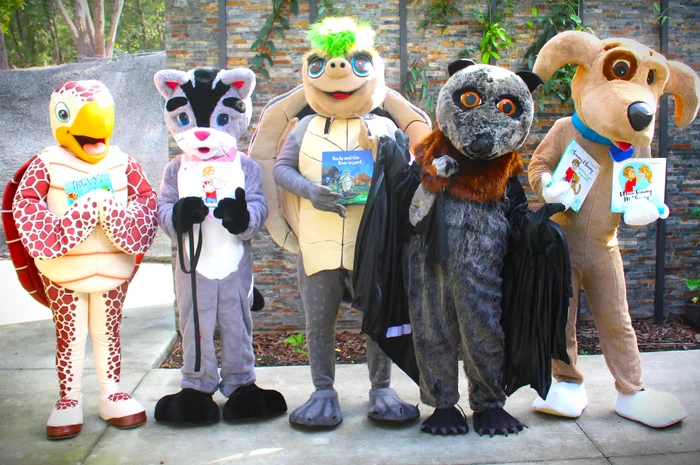 Council animal mascot people in the costumes holding books. Turtle, Cat, water turtle, Bat and dog. 
