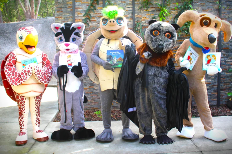 Council animal mascot people in the costumes holding books. Turtle, Cat, water turtle, Bat and dog. 
