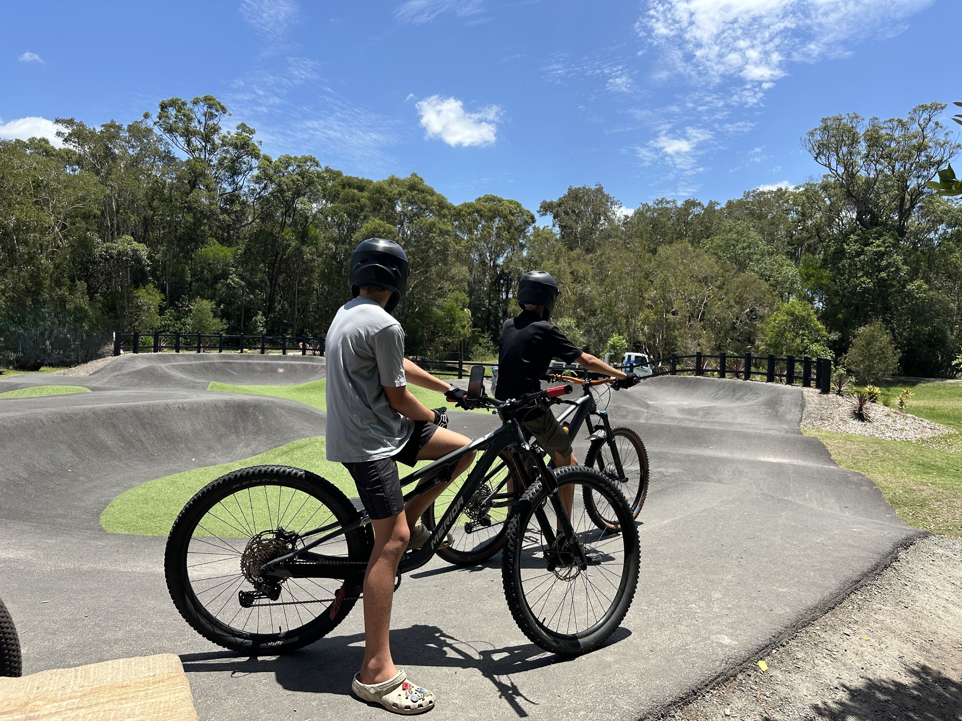 Two boys on mountain bikes at pump track