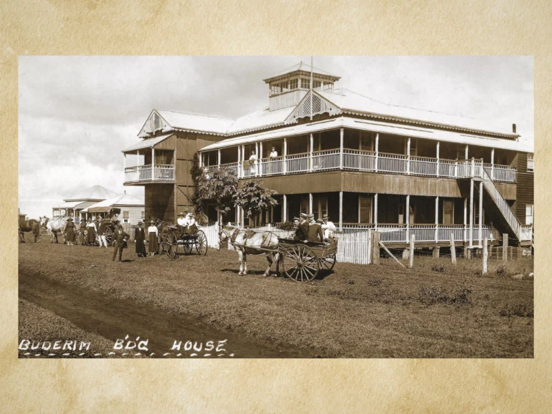 A historical photograph of a double-storey colonial style house in Buderim, with horses and passenger carts in front.