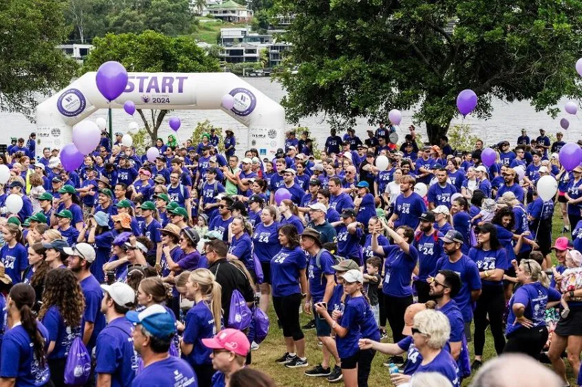 A crowd of people dressed in purple