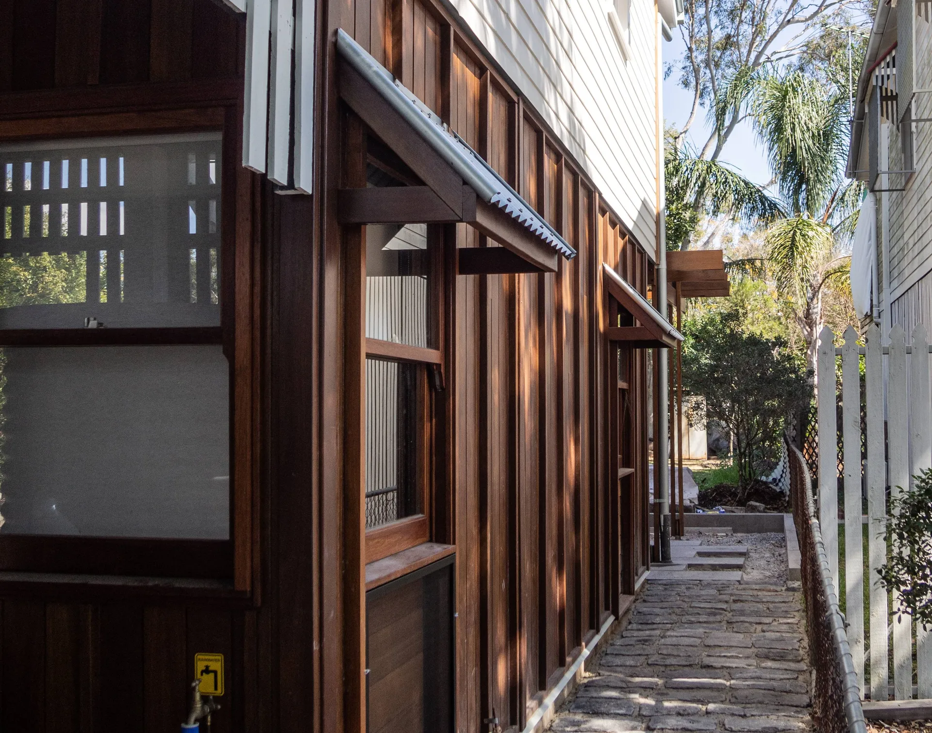 A pathway runs alongside a house that has utilised resilient design.