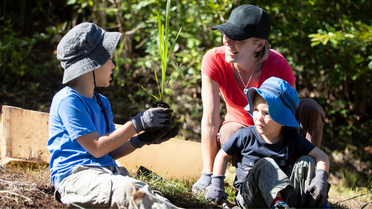 Mother and sons planting Australian natives