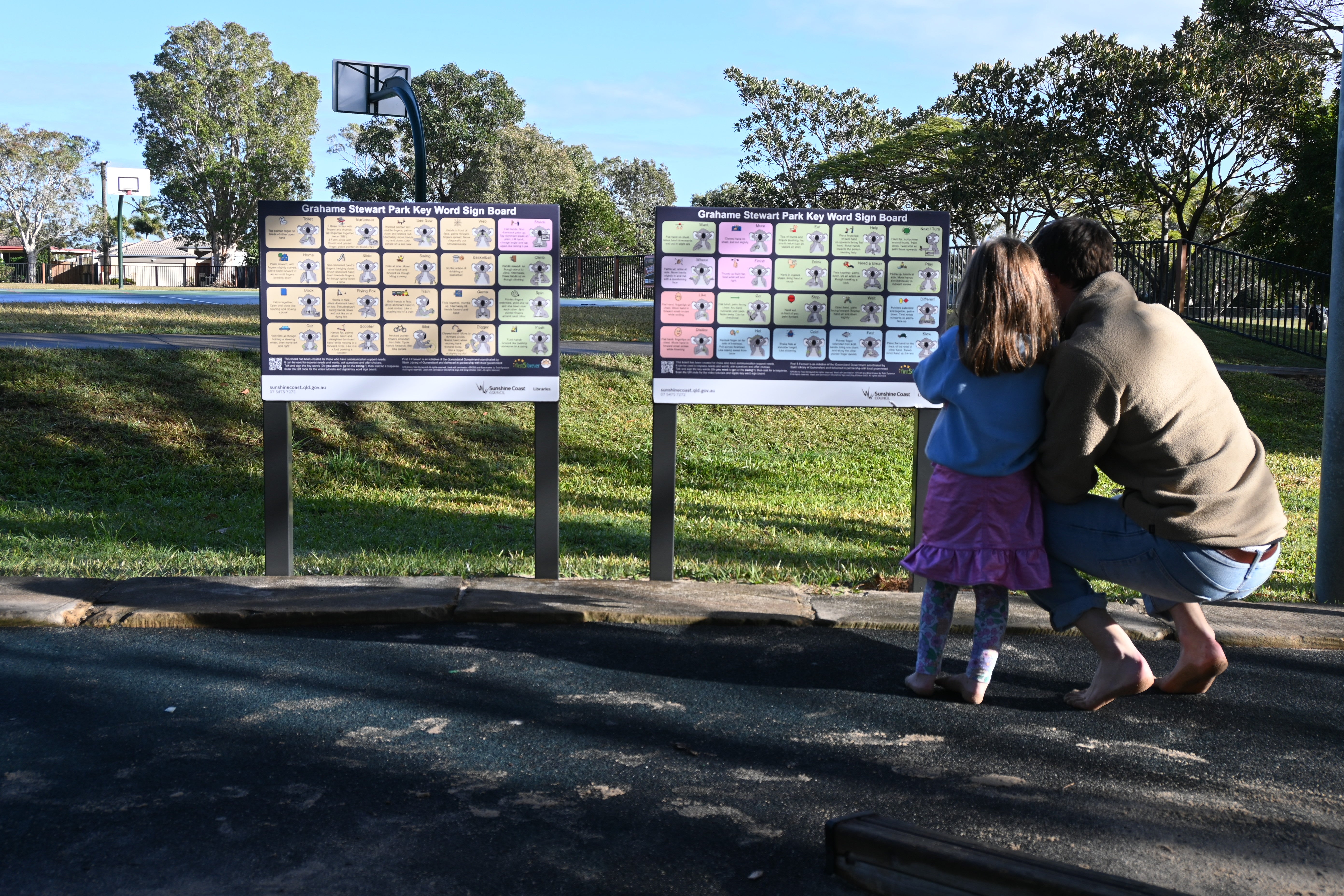 Parent and child interacting at Communication boards