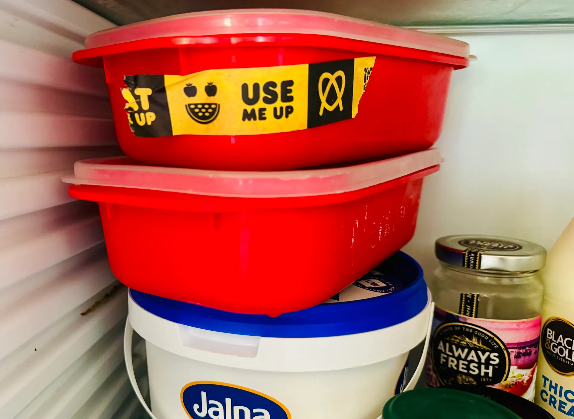 container in fridge with use it up tape