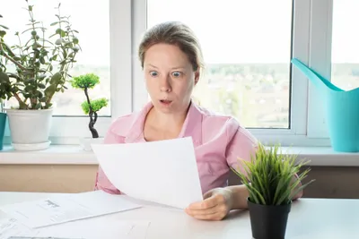 lady looking at an energy bill in shock