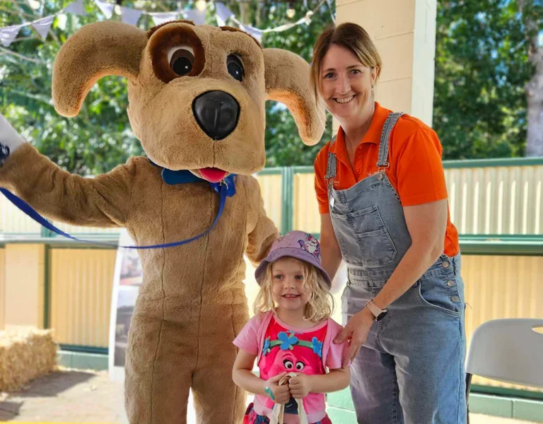 Mascot Sunny, Council Community & Animal Education Supervisor Hannah Maloney and child