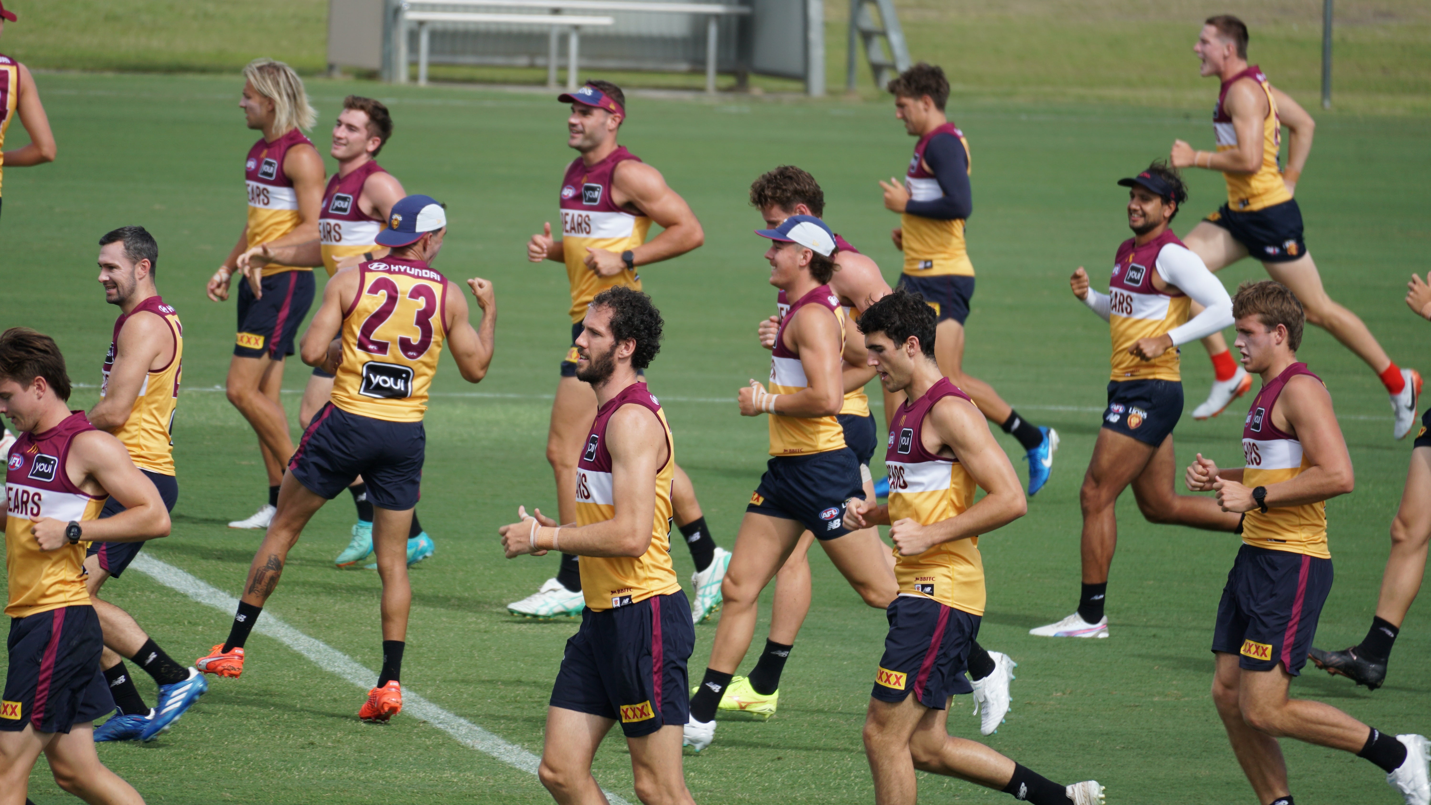 A number of 2025 Brisbane Lions jogging on field