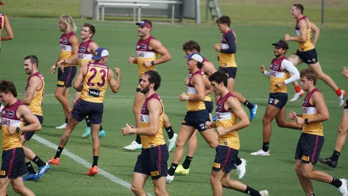 A number of 2025 Brisbane Lions jogging on field