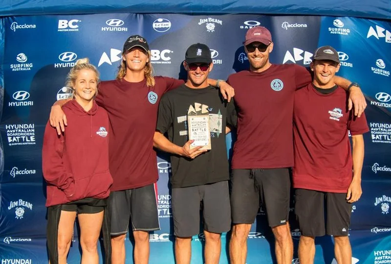 Five members of North Shore Boardriders holding their prize as winners of the 2023 Hyundai Australian Boardriders Battle (ABB) Queensland qualifier. 